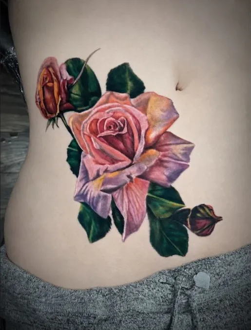 Large color realism pink rose tattoo on the stomach