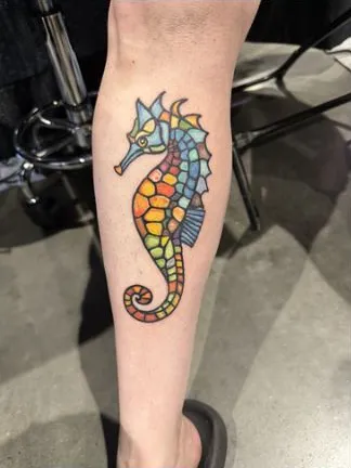 Stained glass style seahorse tattoo on the calf